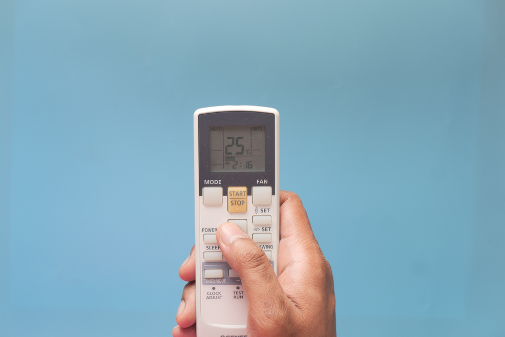 Close up of Man Hand Holding Air Condition Remote.