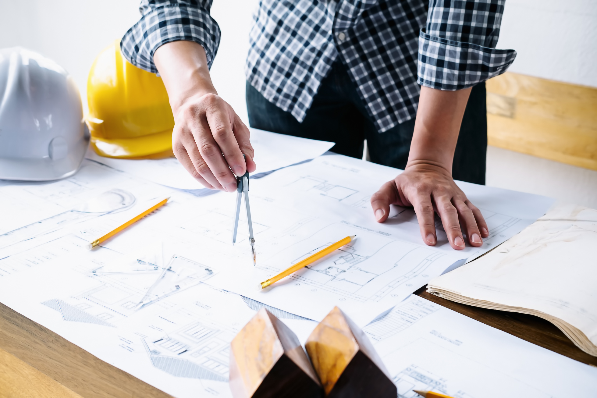 Architect Using Compass on Blueprint Construction Project